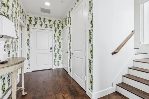 a view of an entryway with wooden floor