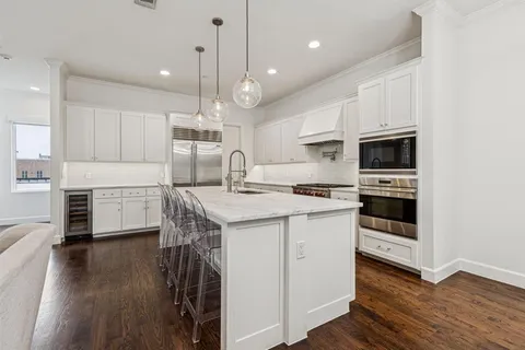 a kitchen with a sink stainless steel appliances and cabinets
