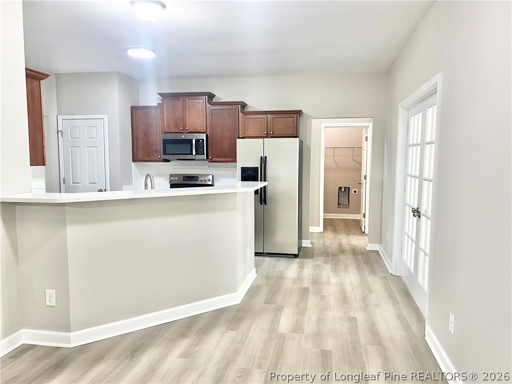 1523 Rough Rider Lane Parkton, NC 28371 - Photo 14 of 42 a kitchen with stainless steel appliances a refrigerator and a stove top oven