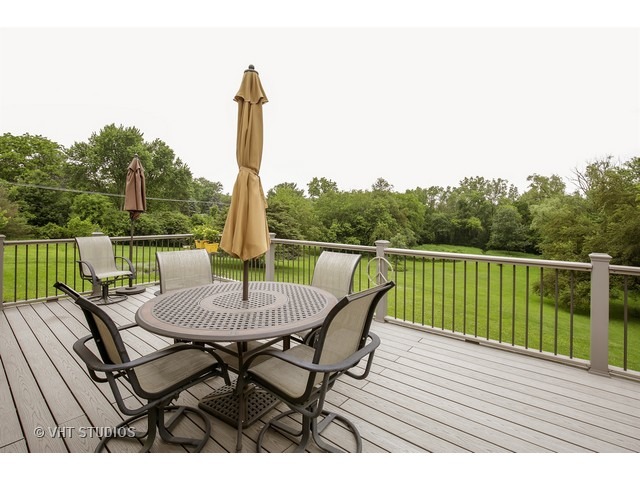 3N873 Cibis Road St. Charles, IL 60175 - Photo 16 of 19 a view of a roof deck with table and chairs a barbeque with wooden floor