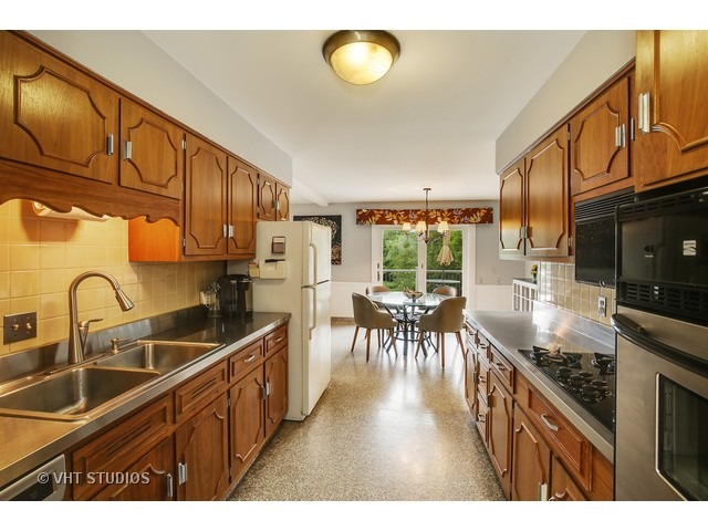 3N873 Cibis Road St. Charles, IL 60175 - Photo 3 of 19 a kitchen with granite countertop a sink a counter top space appliances and cabinets