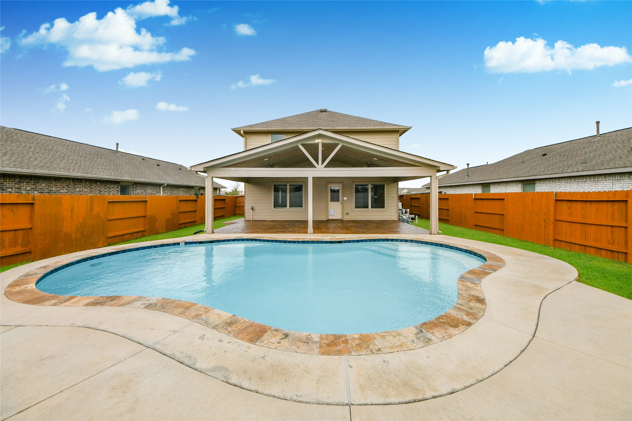 a view of a swimming pool with an outdoor seating