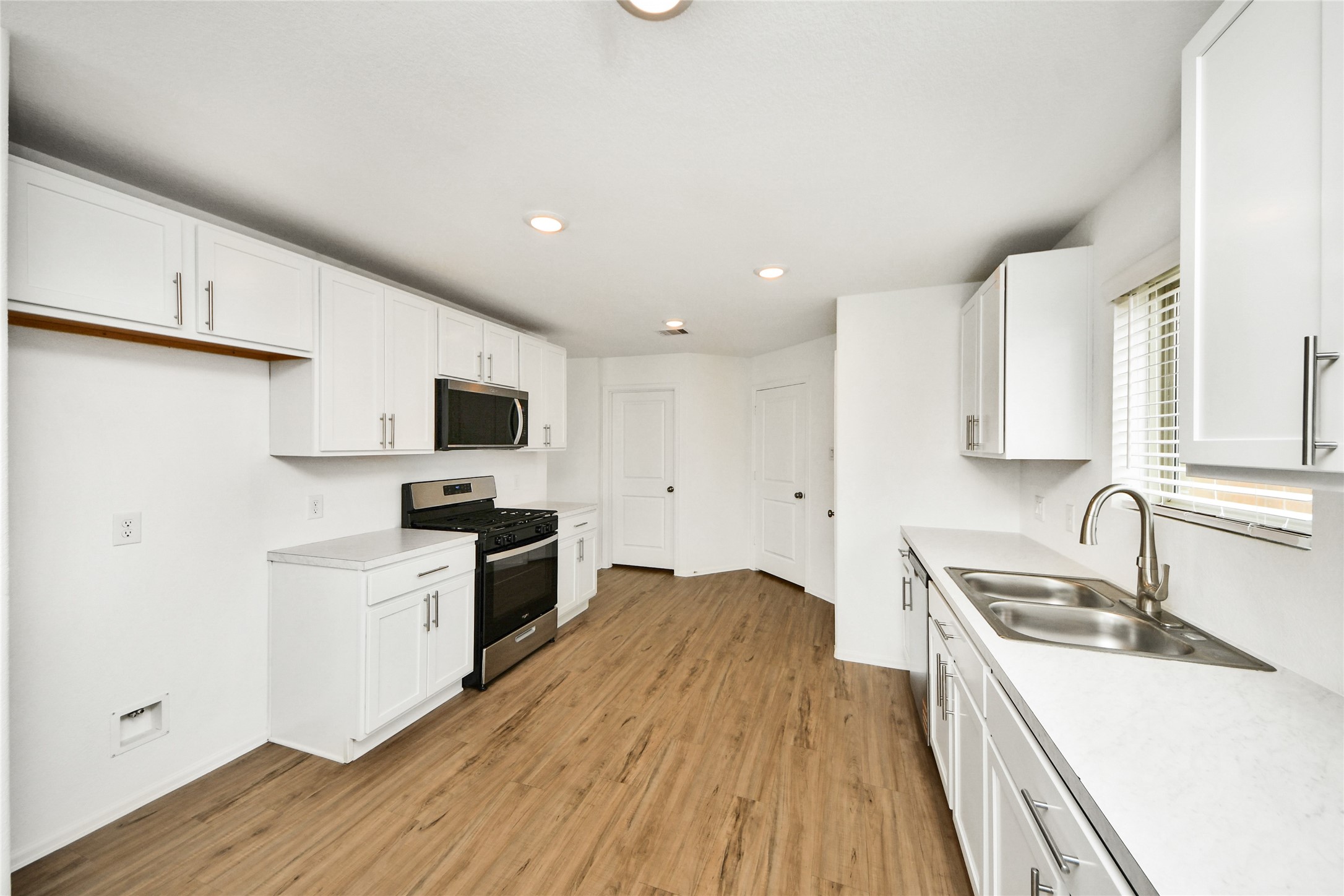 5011 Stratton Lane Rosharon, TX 77583 - Photo 11 of 38 a kitchen with a sink a counter top space stainless steel appliances and cabinets