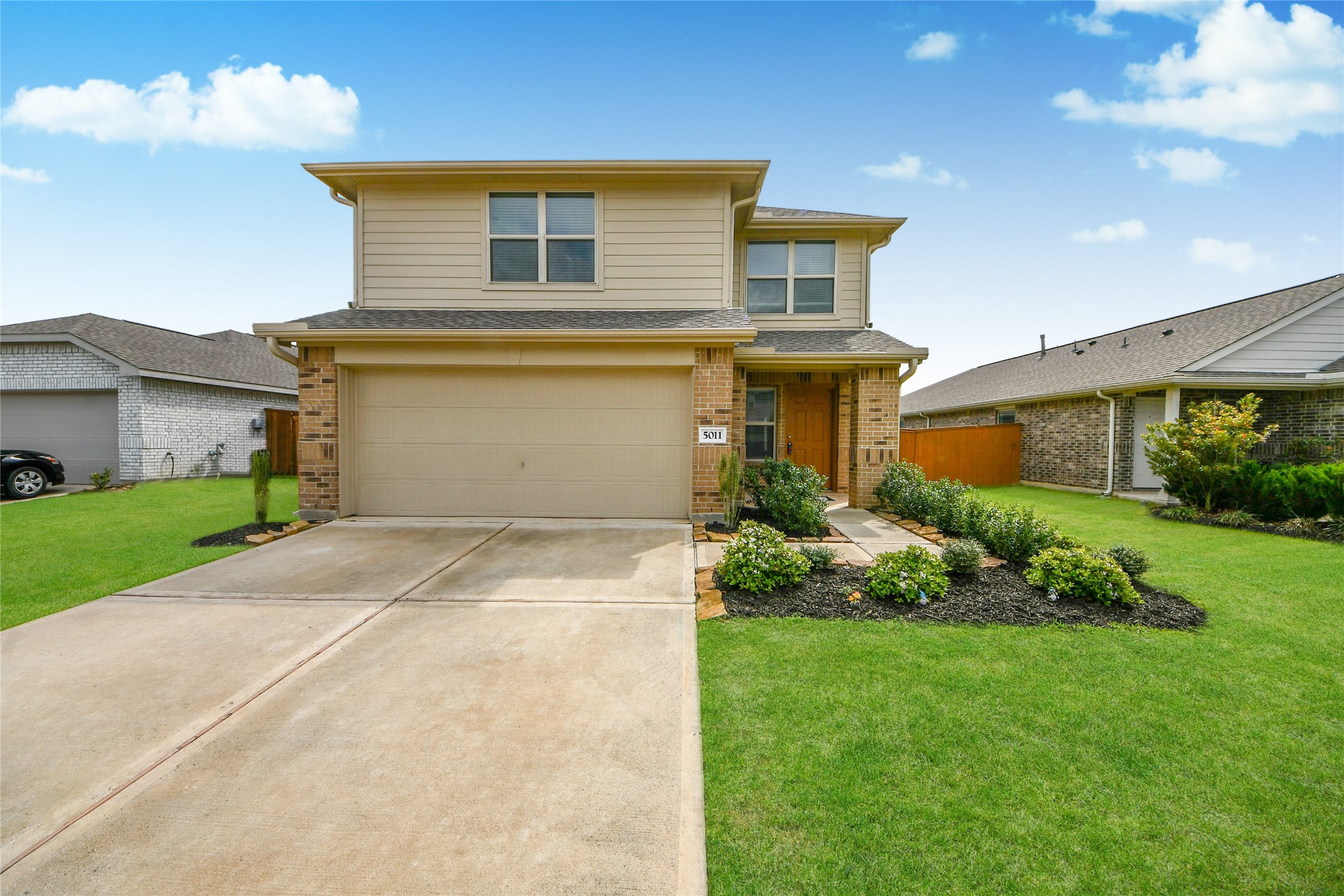 5011 Stratton Lane Rosharon, TX 77583 - Photo 2 of 38 a front view of a house with a garden and plants