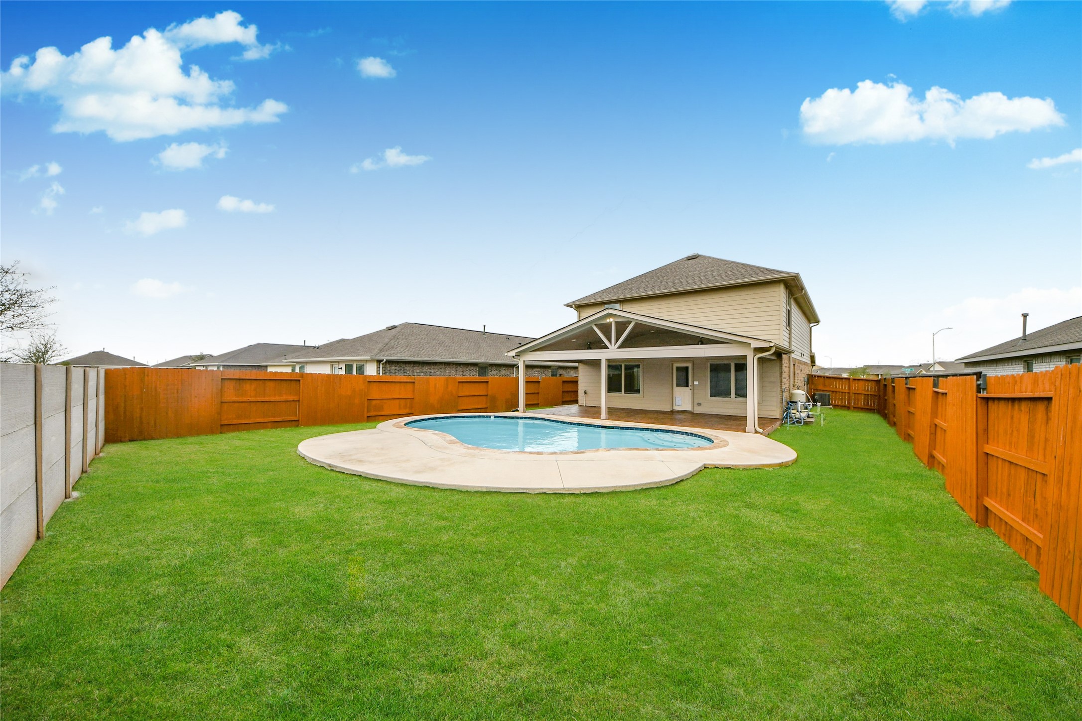 5011 Stratton Lane Rosharon, TX 77583 - Photo 31 of 38 a view of a swimming pool with a yard and a large tree