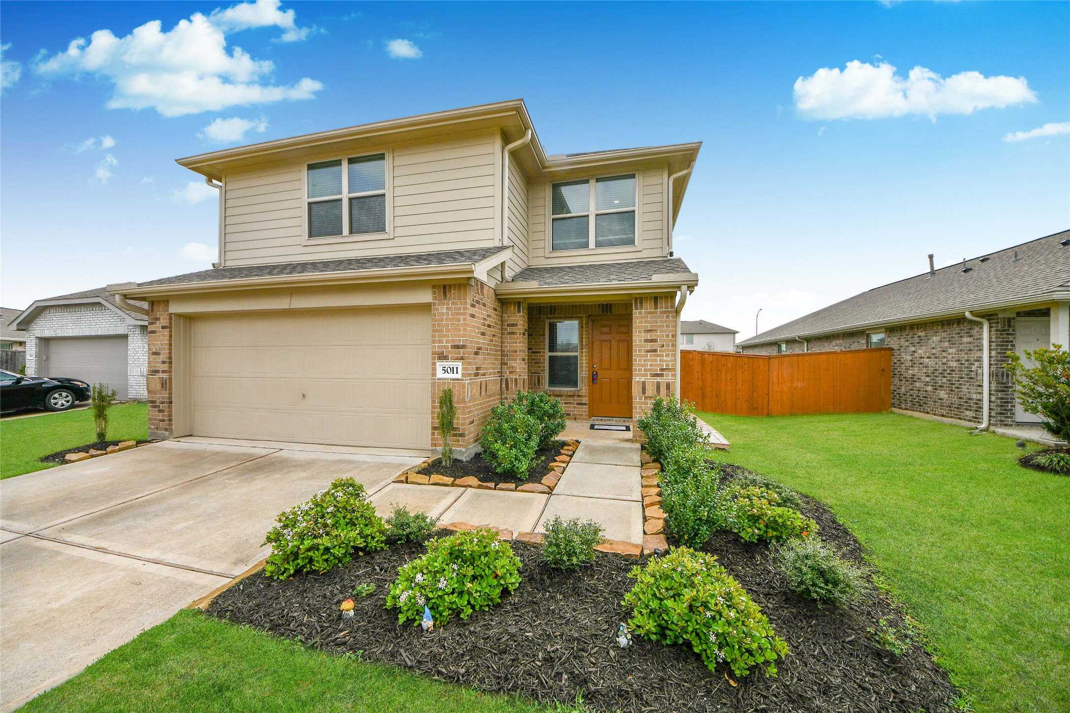 5011 Stratton Lane Rosharon, TX 77583 - Photo 4 of 38 a front view of a house with a yard and garage