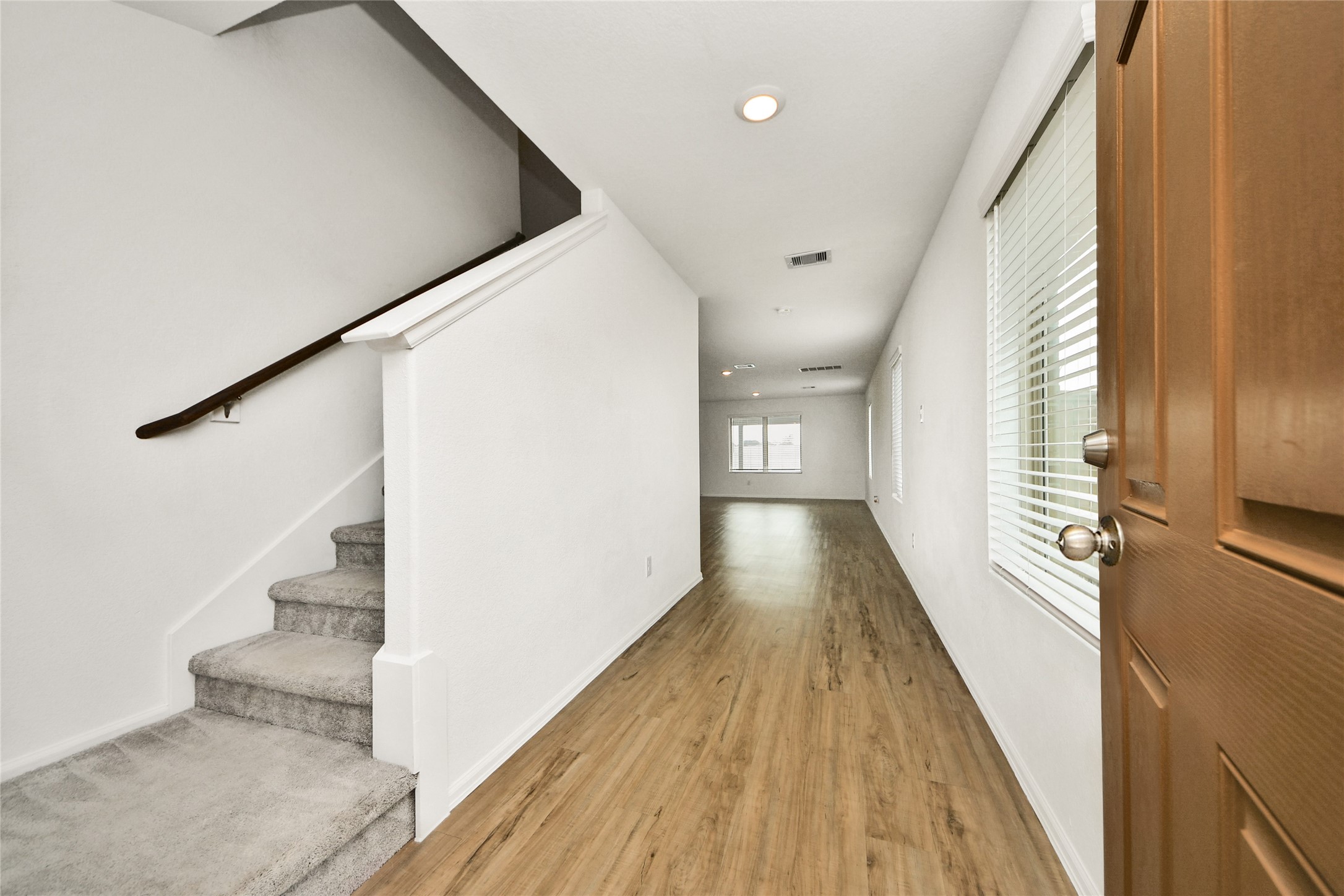 5011 Stratton Lane Rosharon, TX 77583 - Photo 5 of 38 a view of a hallway with wooden floor and staircase
