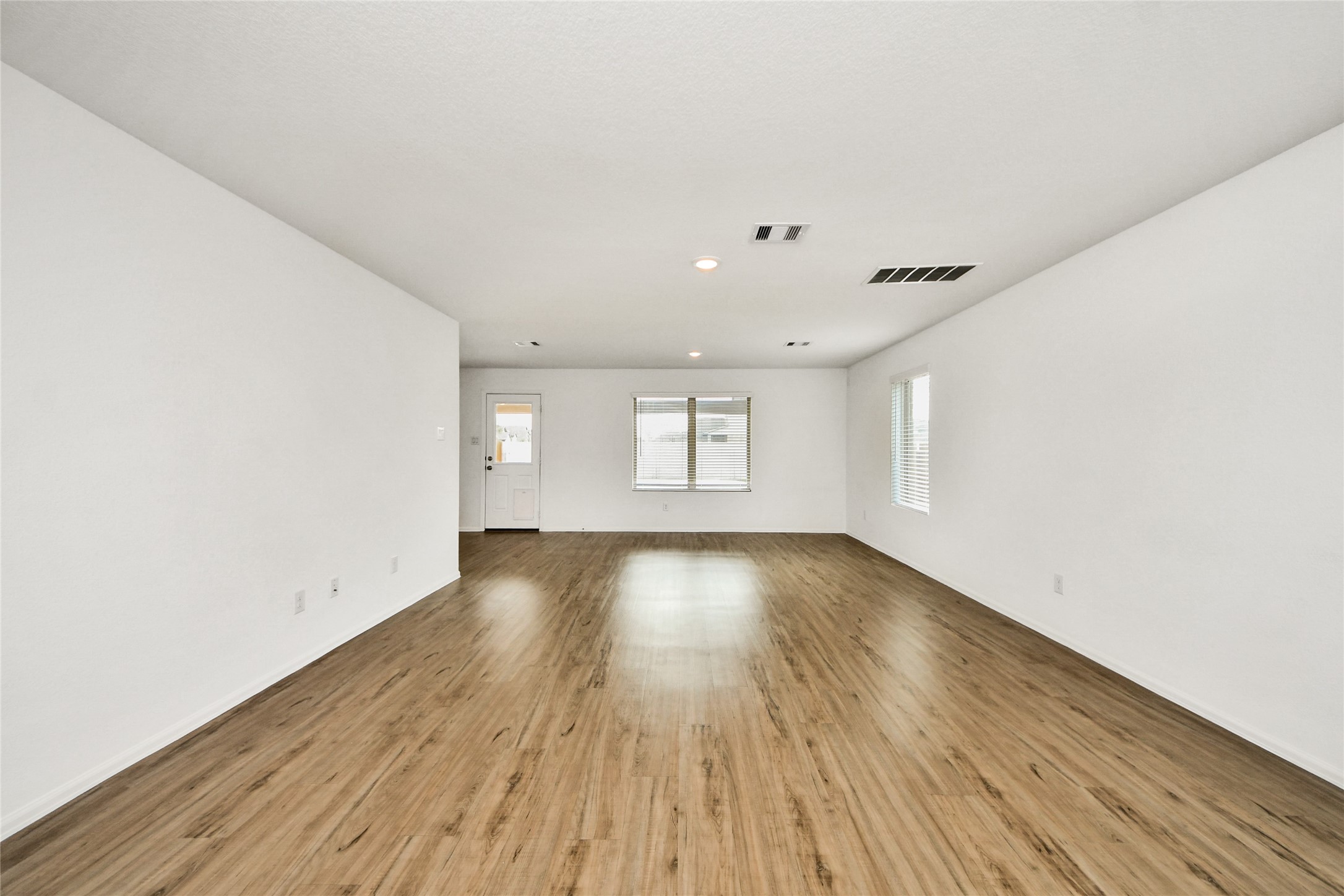 5011 Stratton Lane Rosharon, TX 77583 - Photo 6 of 38 an empty room with wooden floor and windows