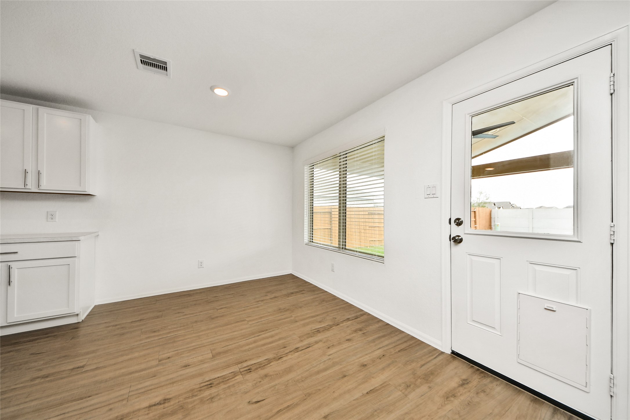 5011 Stratton Lane Rosharon, TX 77583 - Photo 9 of 38 a view of an empty room with wooden floor and a window