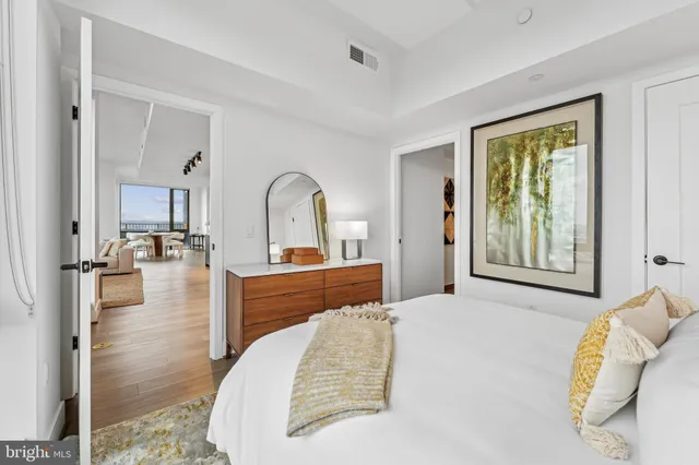 a bedroom with a bed and a large window