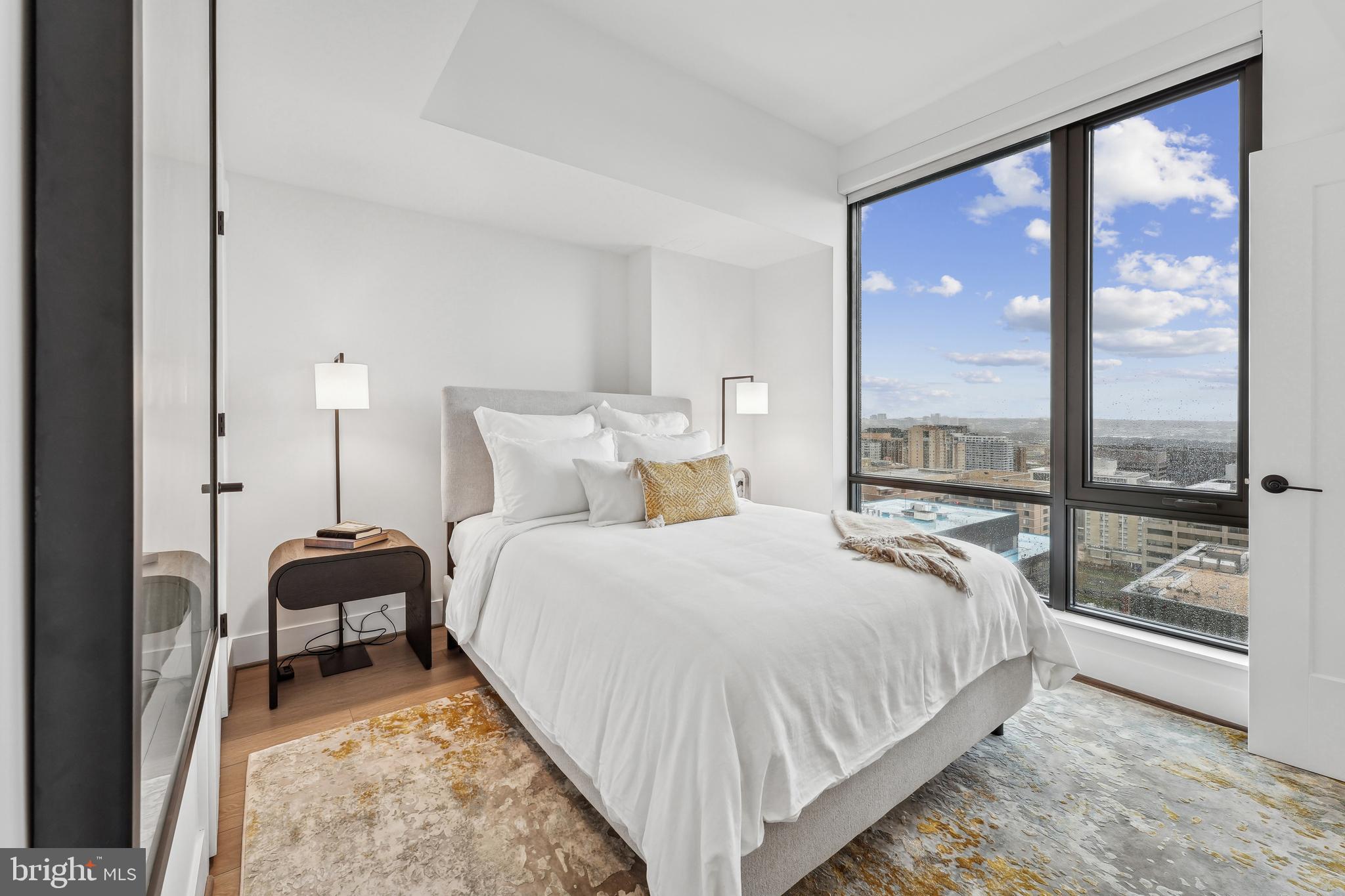 269 19th Court South, Unit 2315 Arlington, VA 22202 - Photo 12 of 48 a bedroom with a bed and a large window