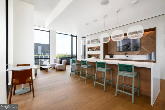 a kitchen with a sink and chairs