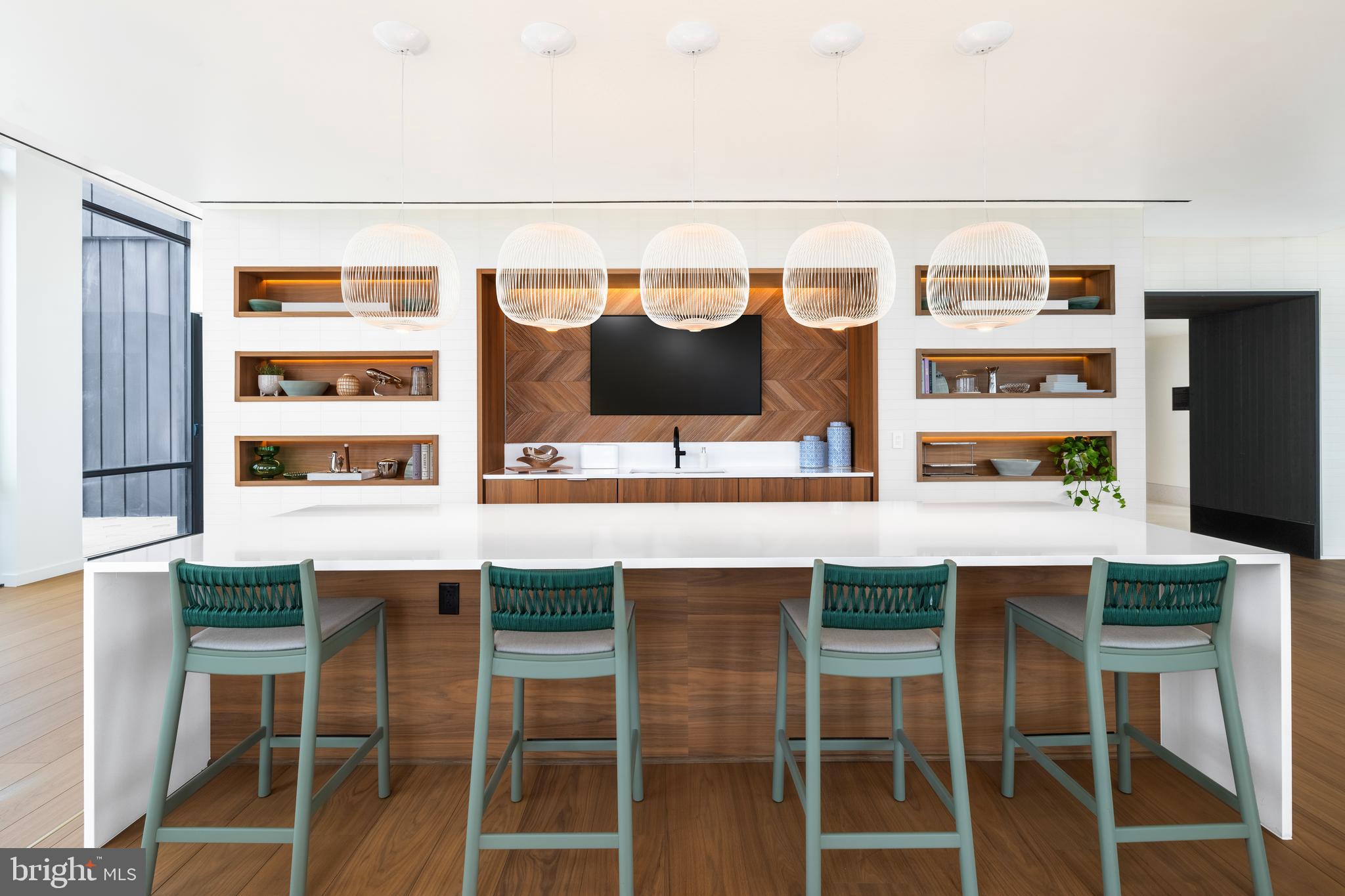 269 19th Court South, Unit 2315 Arlington, VA 22202 - Photo 19 of 48 a kitchen with a sink and chairs