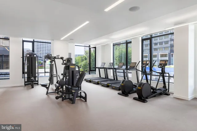 a lobby with furniture and floor to ceiling window