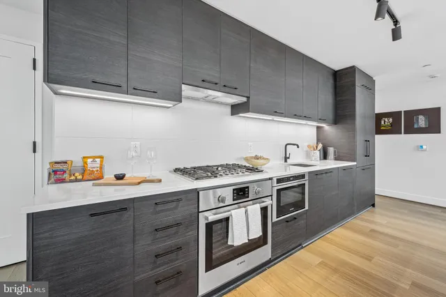a kitchen with a stove and a white cabinets