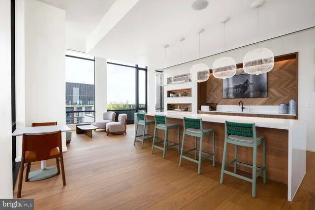 a kitchen with a sink and chairs