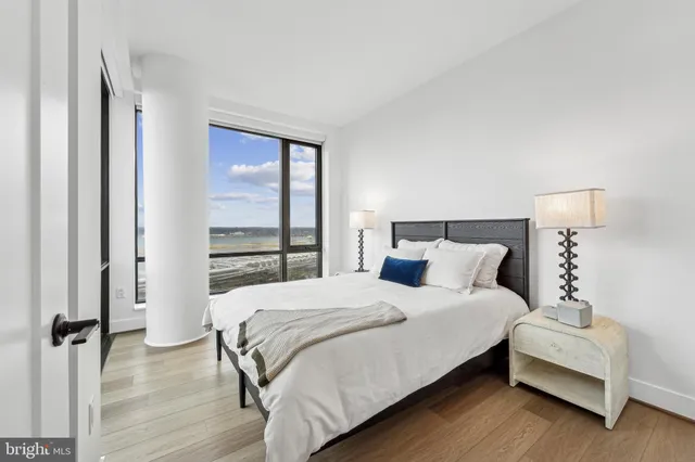 a bedroom with a bed and a large window