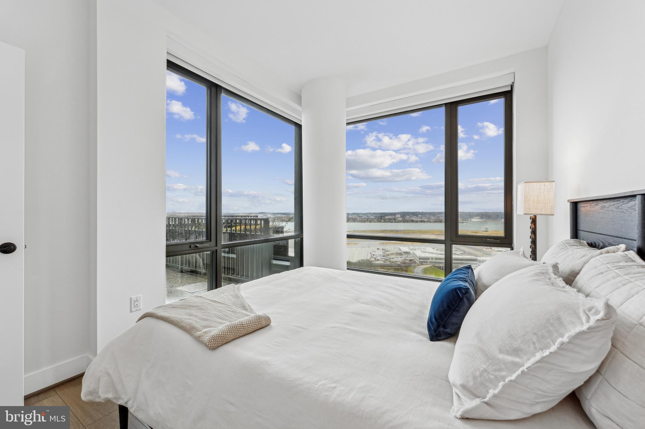 269 19th Court South, Unit 2315 Arlington, VA 22202 - Photo 8 of 48 a bedroom with a bed and large windows