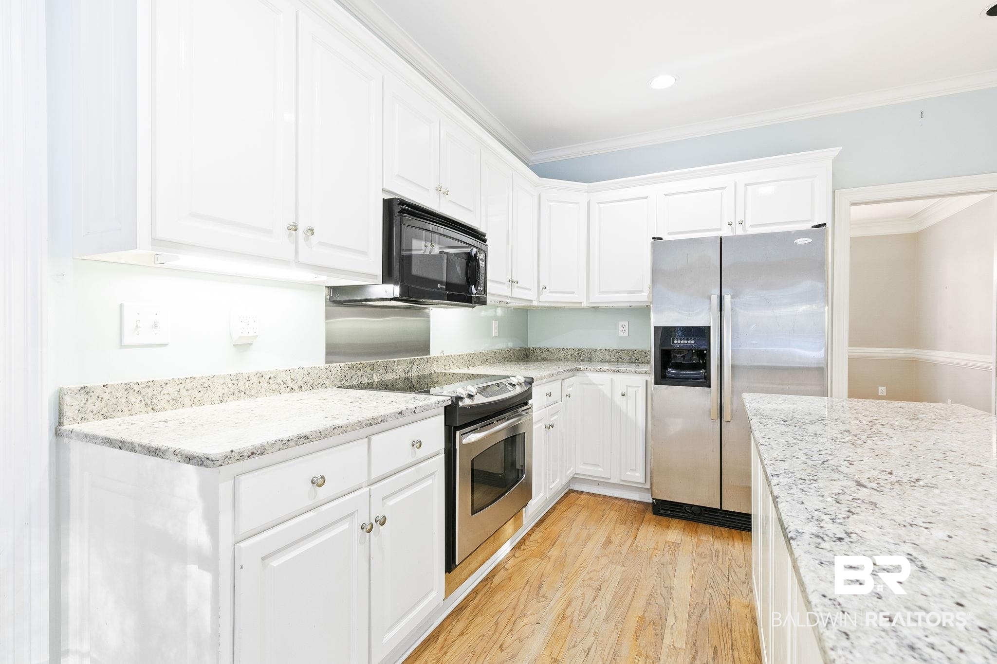 2100 Stonebrook Drive West Mobile, AL 36695 - Photo 18 of 60 Kitchen with white cabinetry, crown molding, and appliances with stainless steel finishes