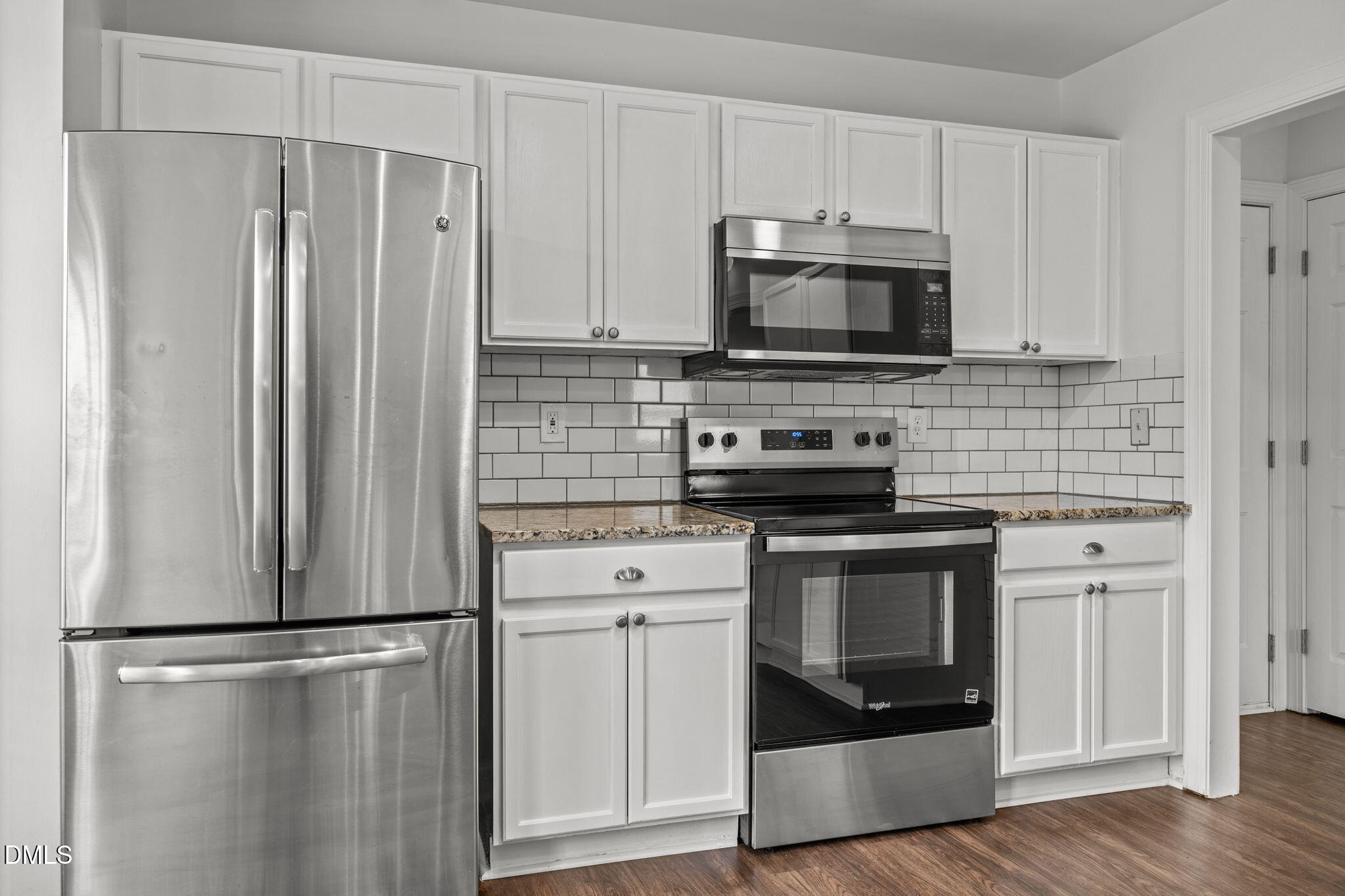 9220 Pennythorne Court Raleigh, NC 27615 - Photo 19 of 49 a kitchen with stainless steel appliances a refrigerator stove and microwave