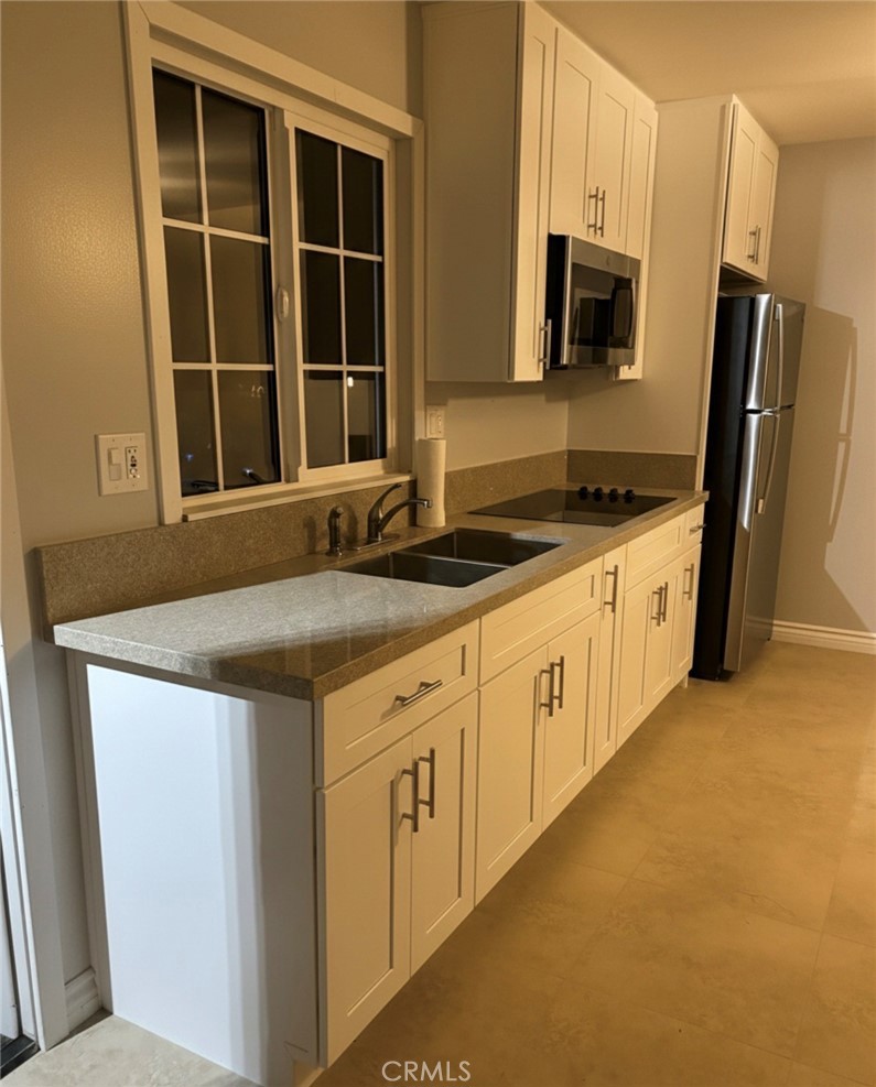 5604 Tower Road Riverside, CA 92506 - Photo 64 of 70 a kitchen with stainless steel appliances granite countertop a stove and a refrigerator