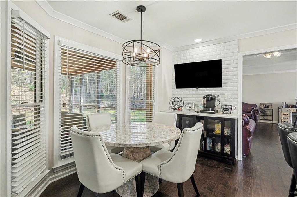 570 Morgan Court Hampton, GA 30228 - Photo 3 of 31 a view of a dining room with furniture window and wooden floor