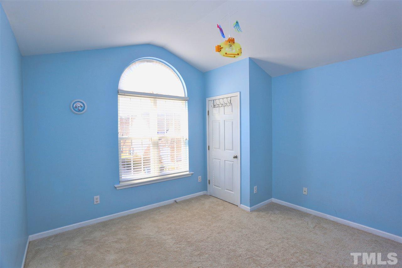 2134 Metacomet Way Raleigh, NC 27604 - Photo 17 of 25 an empty room with windows and wooden floor
