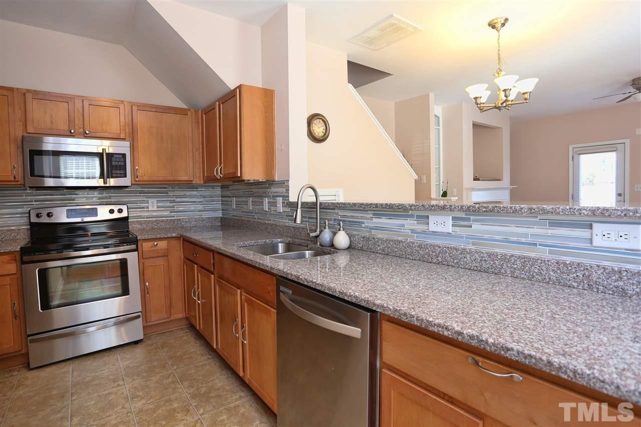 2134 Metacomet Way Raleigh, NC 27604 - Photo 4 of 25 a kitchen with stainless steel appliances granite countertop a sink and a microwave