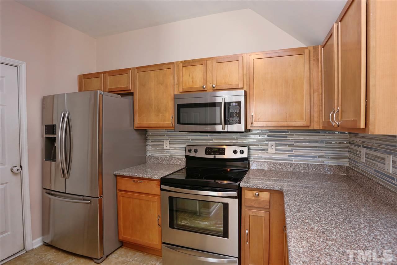 2134 Metacomet Way Raleigh, NC 27604 - Photo 6 of 25 a kitchen with stainless steel appliances a stove microwave and refrigerator