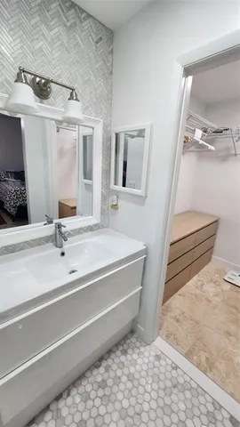 a bathroom with a sink and a mirror