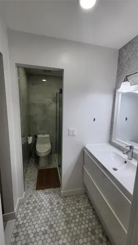 a bathroom with a toilet and a shower
