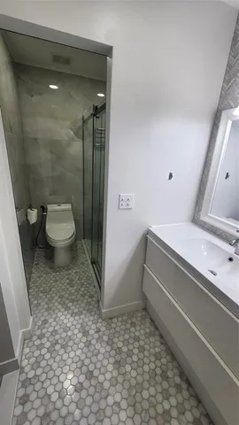 a bathroom with a toilet and a shower