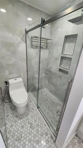 a bedroom with a bed and a television