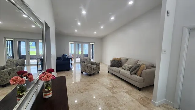 a living room with furniture and a chandelier