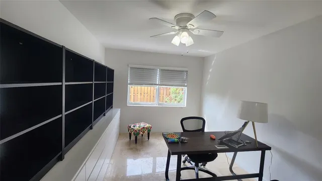 a view of a workspace room with furniture and wooden floor