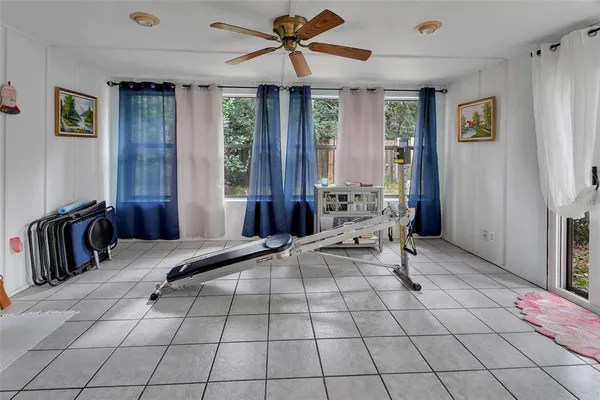 a bedroom with a bed a chandelier and large window