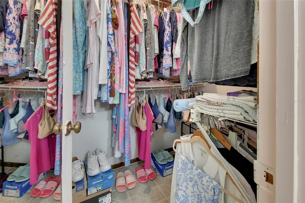 a view of walk in closet with clothes