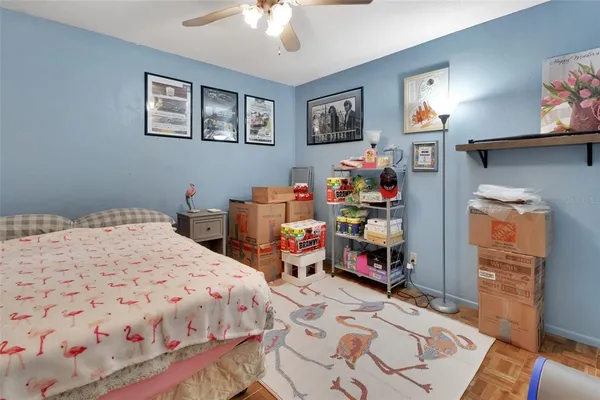 a bedroom with bed and paintings on the wall