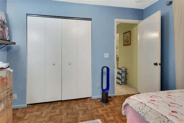 a bedroom with a bed and a mirror