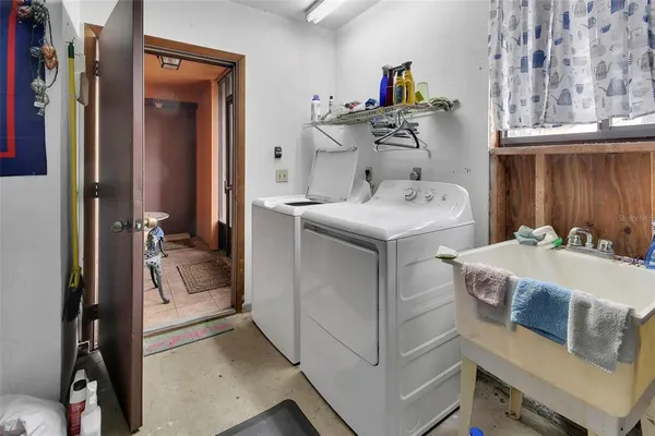 a utility room with a sink dryer and washer