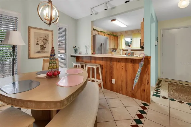 a dining room with granite countertop a sink a mirror and a window