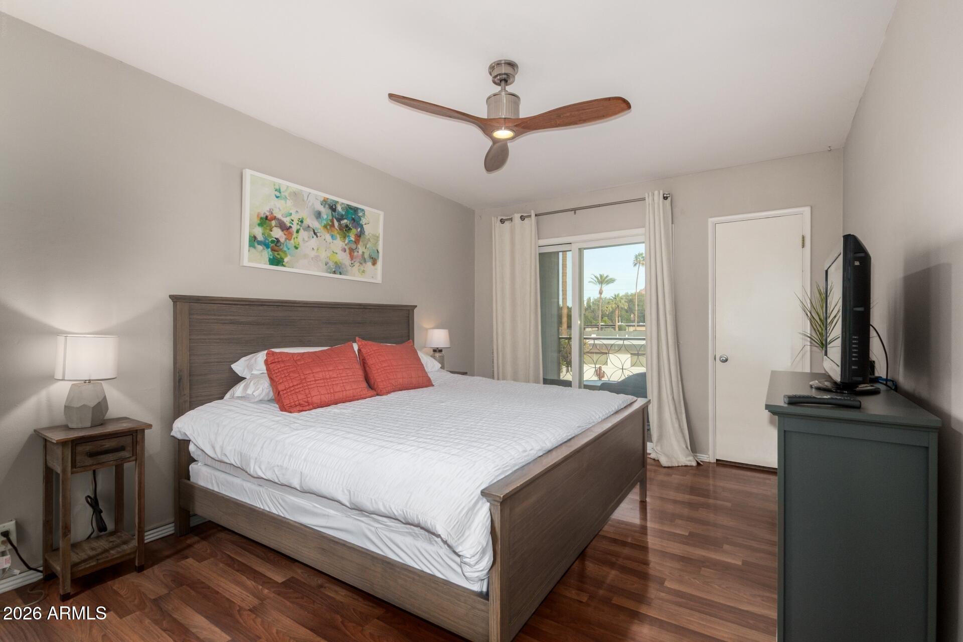 3270 East Camelback Road, Unit 213 Phoenix, AZ 85018 - Photo 14 of 41 a bedroom with a bed and a flat screen tv