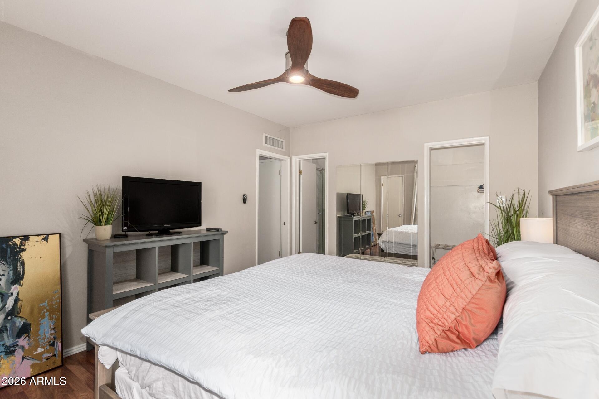 3270 East Camelback Road, Unit 213 Phoenix, AZ 85018 - Photo 15 of 41 a bedroom with a bed and a flat screen tv