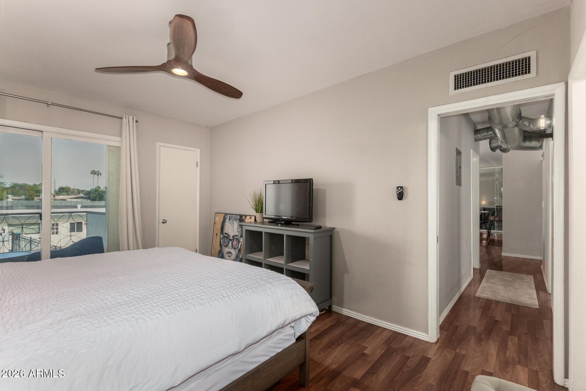 3270 East Camelback Road, Unit 213 Phoenix, AZ 85018 - Photo 16 of 41 a bedroom with a bed and a flat screen tv