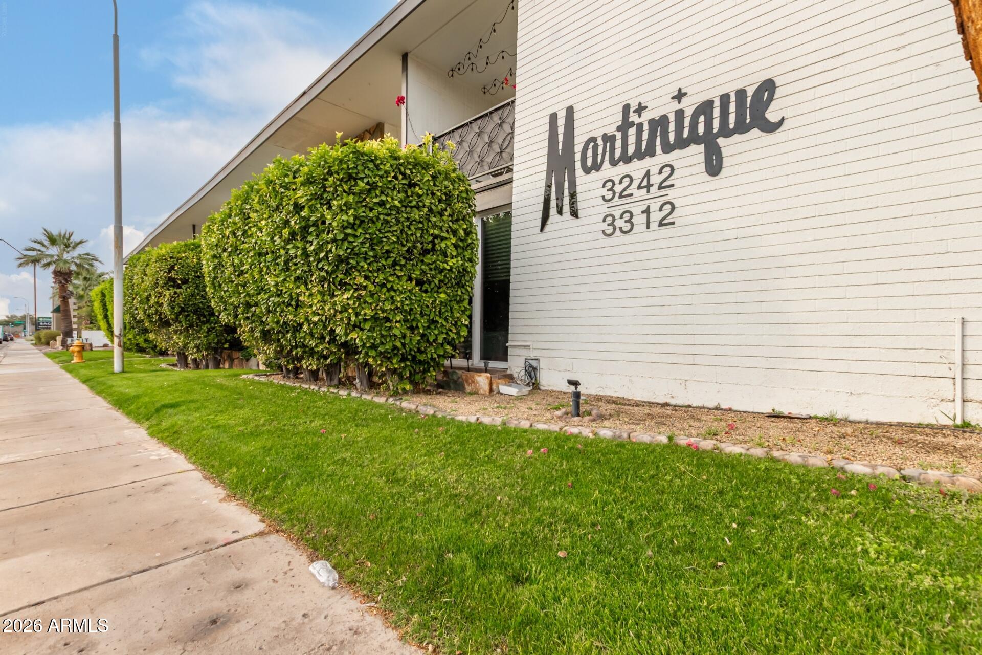 3270 East Camelback Road, Unit 213 Phoenix, AZ 85018 - Photo 2 of 41 a white house with a yard and plants