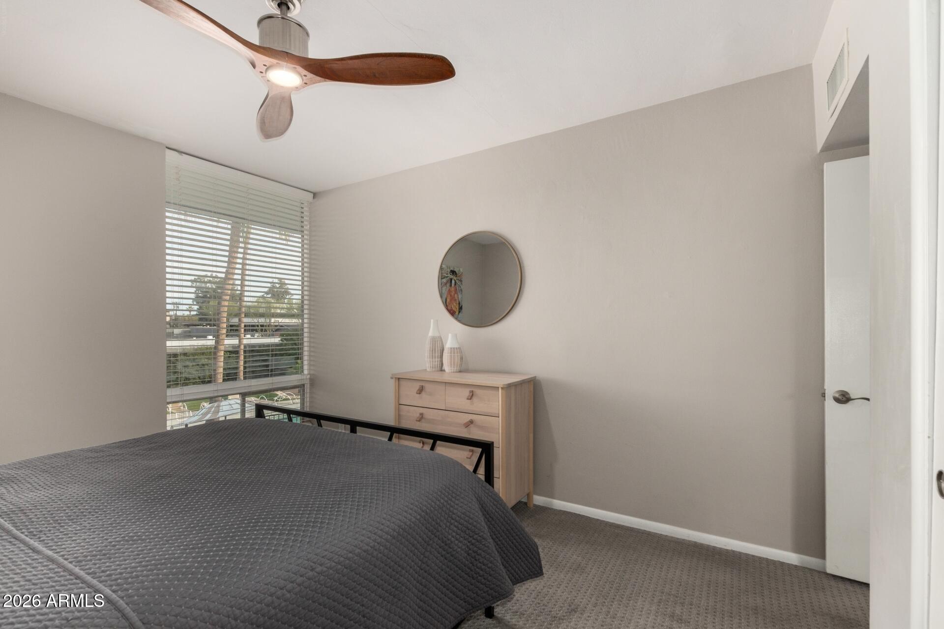 3270 East Camelback Road, Unit 213 Phoenix, AZ 85018 - Photo 22 of 41 a bedroom with a bed and a window