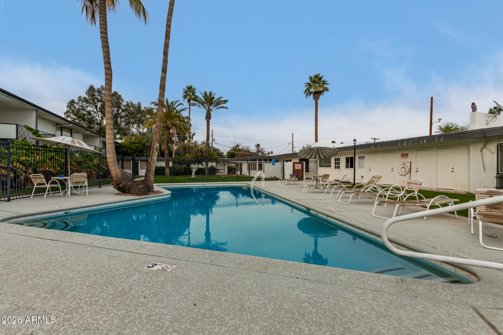 3270 East Camelback Road, Unit 213 Phoenix, AZ 85018 - Photo 34 of 41 a view of a swimming pool with outdoor seating