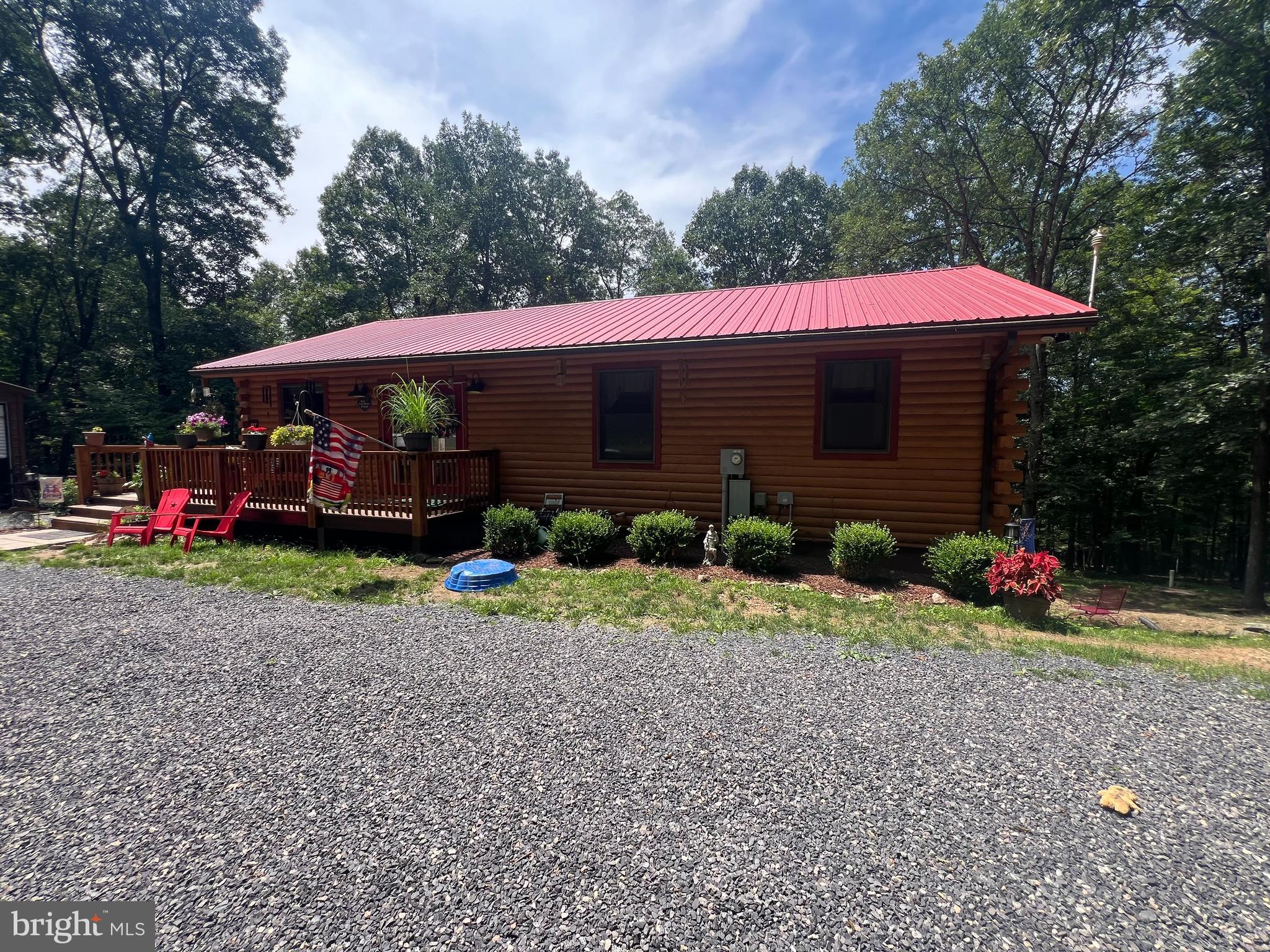480 High Mountain Road Romney, WV 26757 - Photo 2 of 46 a front view of a house with garden