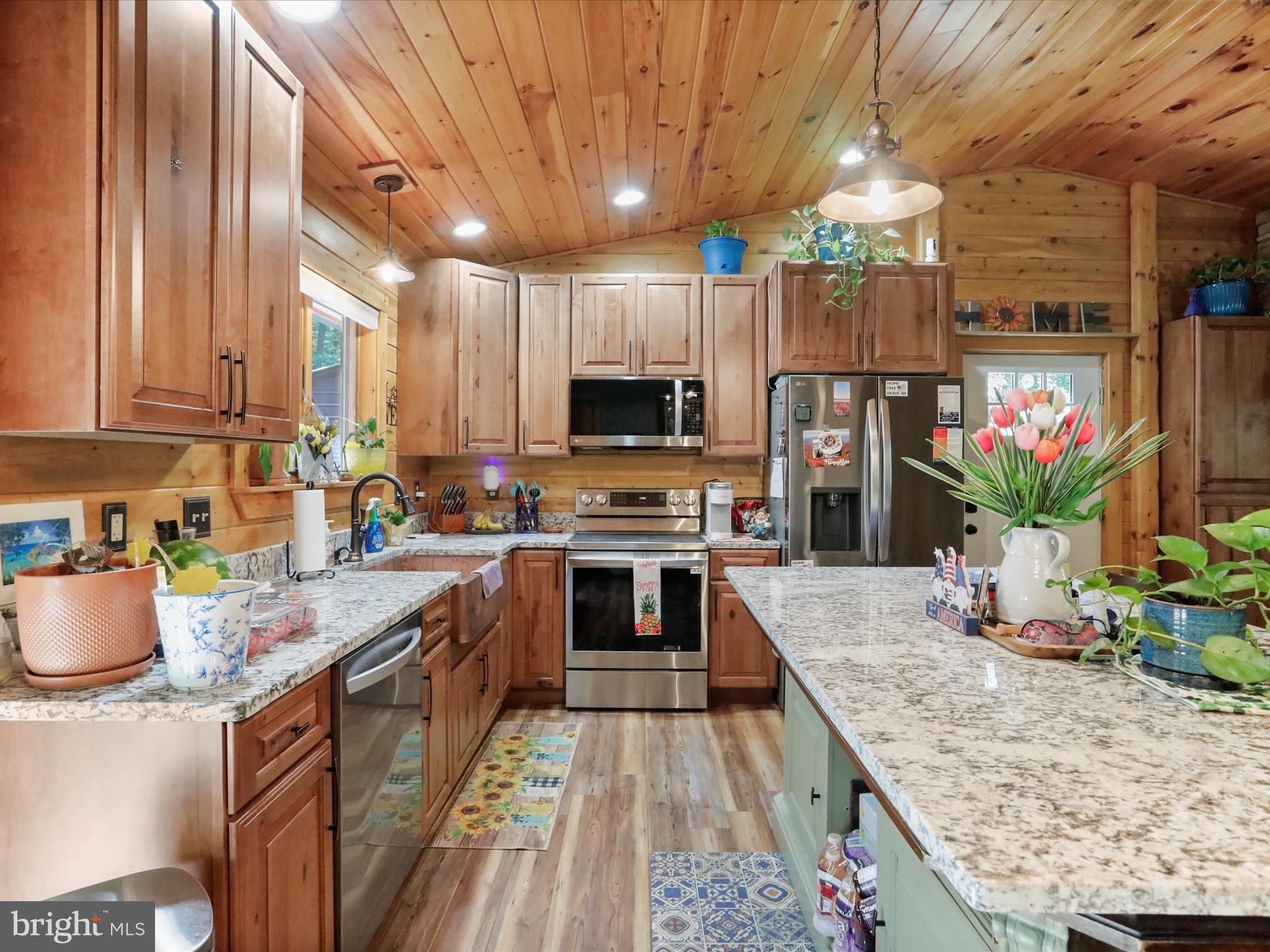 480 High Mountain Road Romney, WV 26757 - Photo 23 of 46 a kitchen with a stove a sink and a refrigerator