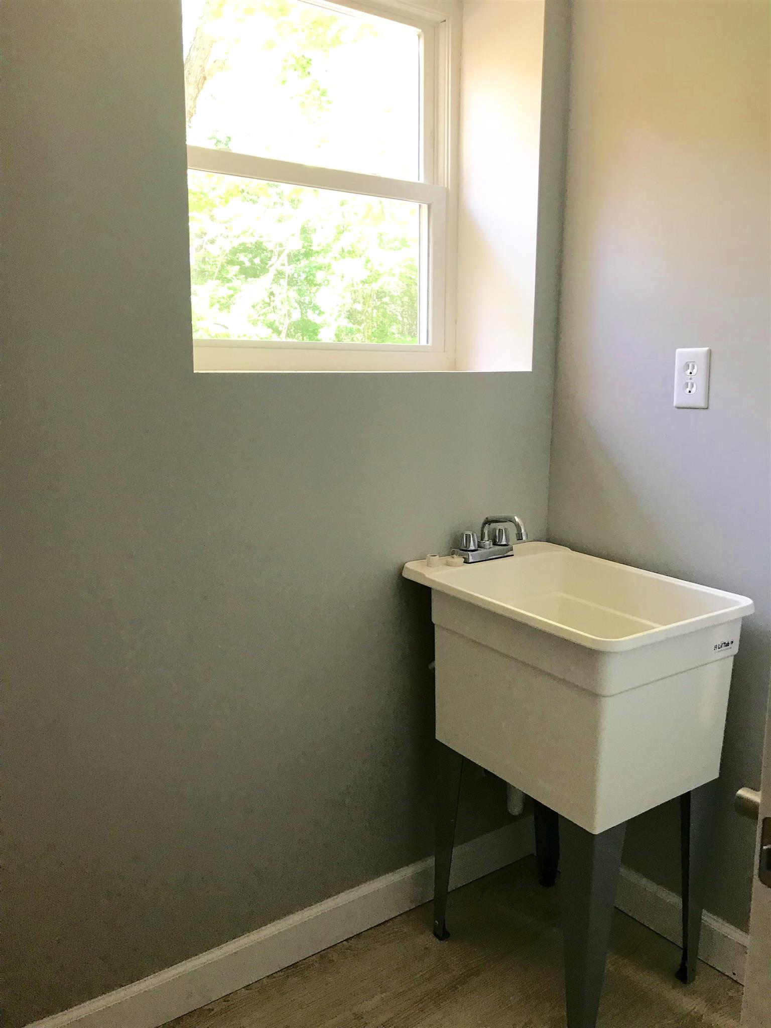 1047 Salem Ridge Road Clarksville, TN 37040 - Photo 15 of 17 a bathroom with a sink a window and a mirror